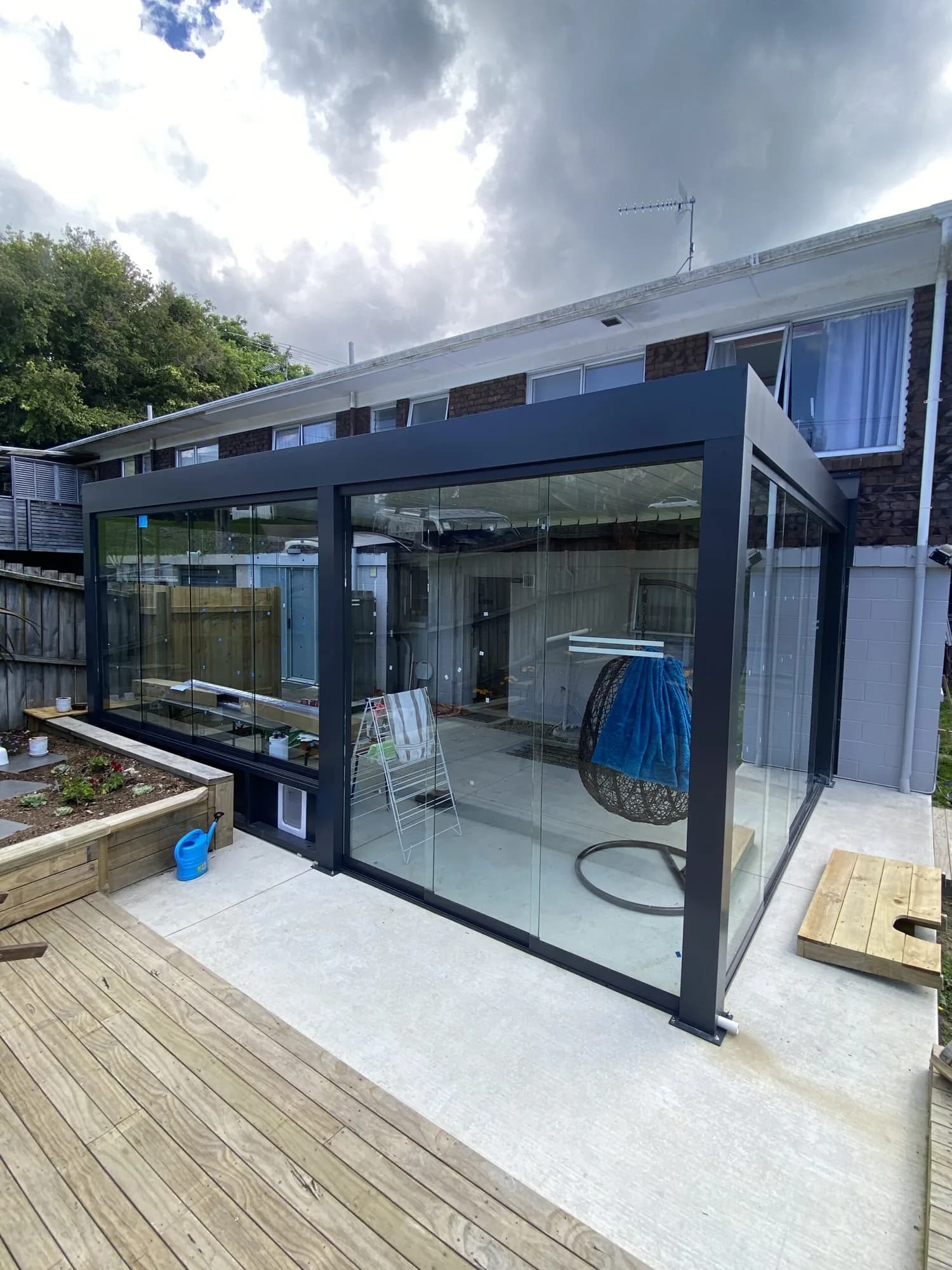 Glass walls closing in an outdoor room on a deck